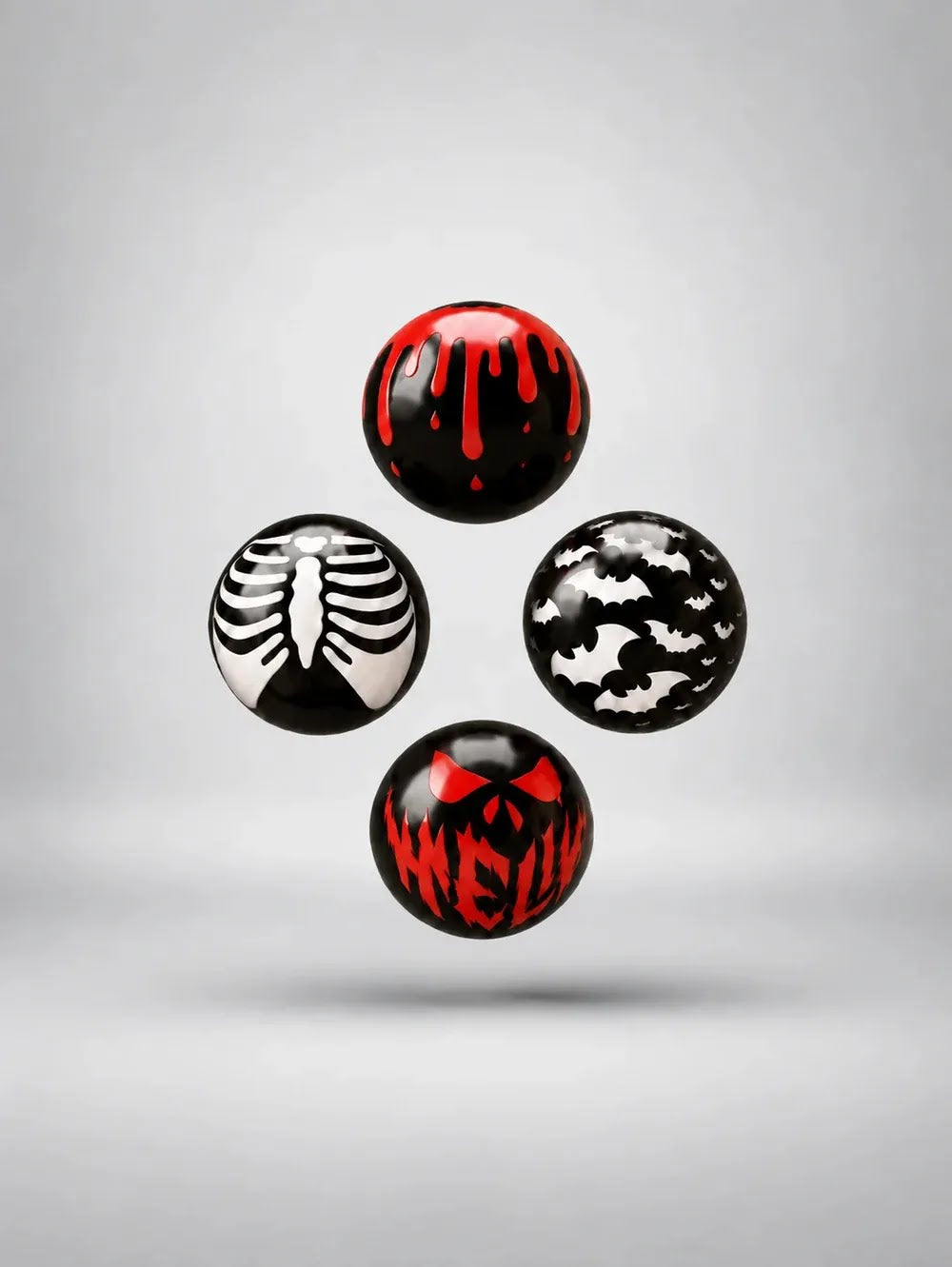 Cuatro bombones con diseños de Halloween: gotas de cera, esqueleto, murciélagos y calabaza, sobre fondo gris claro